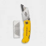 Corta cartón plegable Crownman color amarillo de 150mm junto a un estuche con 5 cuchillas de repuesto